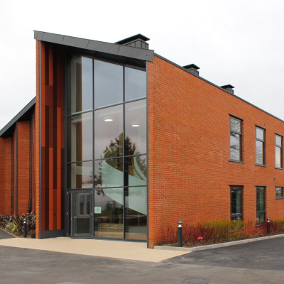 External view of school with glass frontage showing bespoke curved staircase