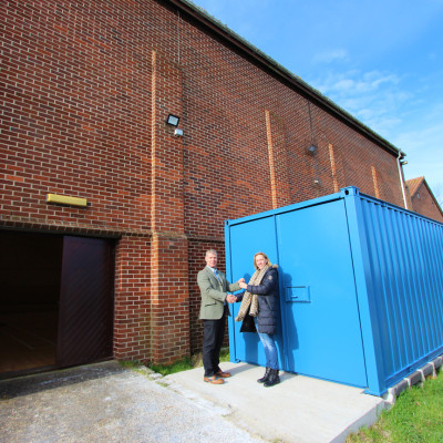 Operations Manager Philip Maxwell hands over donated container to Earls Colne Recreation Centre