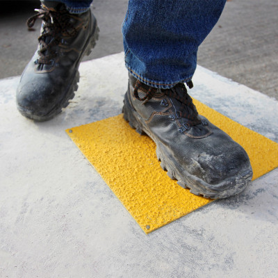 Boot steps on Safe Tread GRP anti-slip hollowcore service hole cover