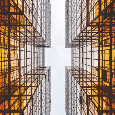 ground view looking up in between sky scraper buildings