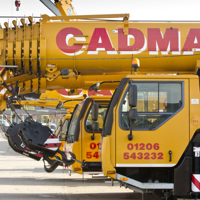 Close up of Cadman Cranes machines parked in a row