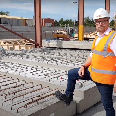 Mark Ellis poses with specialist precast concrete ground beams in production yard