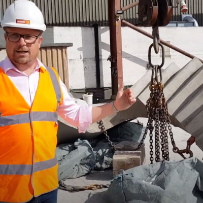 Mark Ellis poses with specialist precast concrete curved staircase in production yard