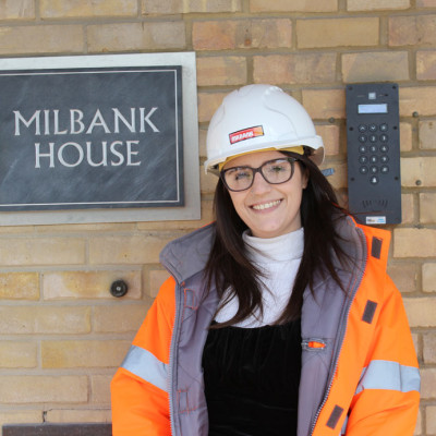 Vikki Lawson poses in front of Milbank House sign for women at milbank feature