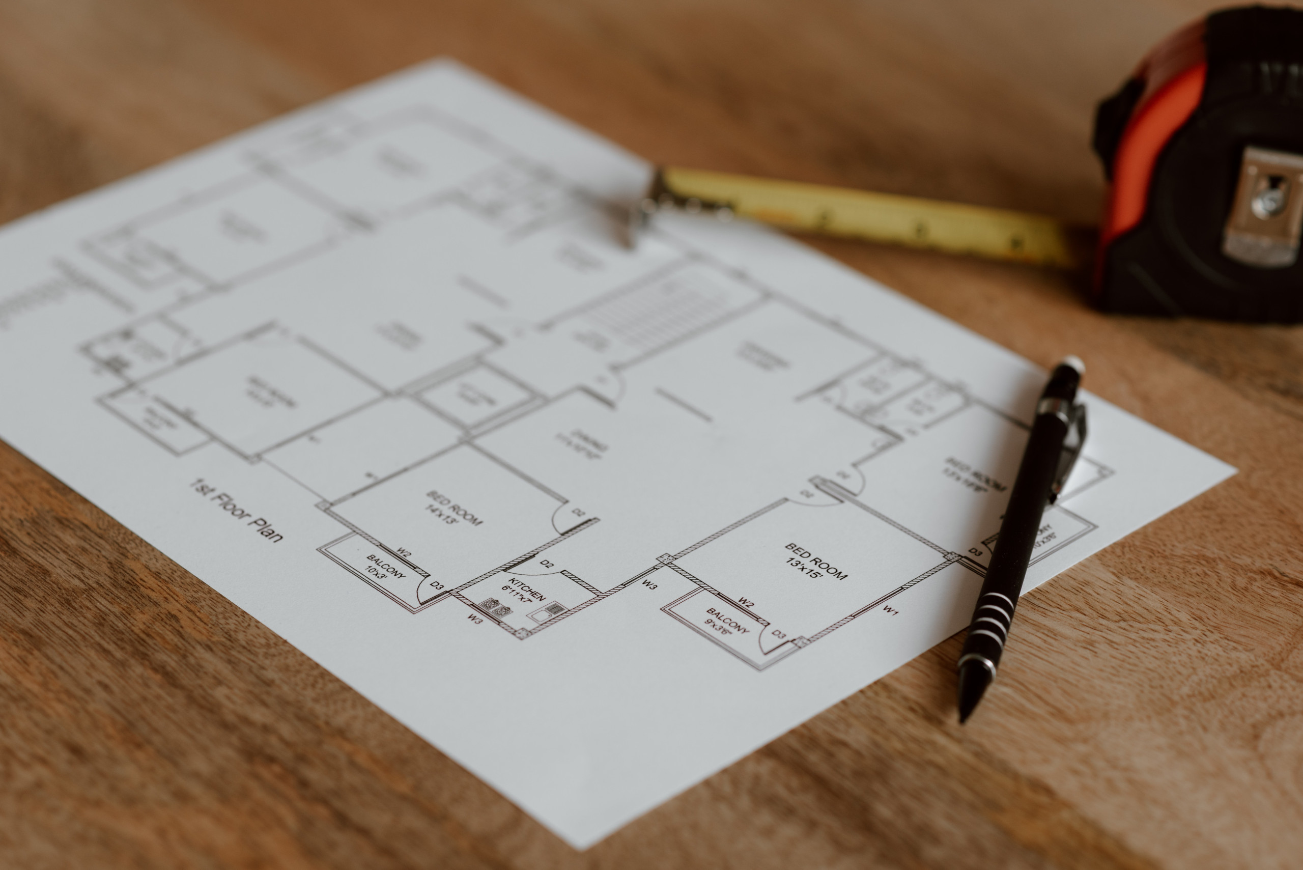 construction drawings with pen and tape measure